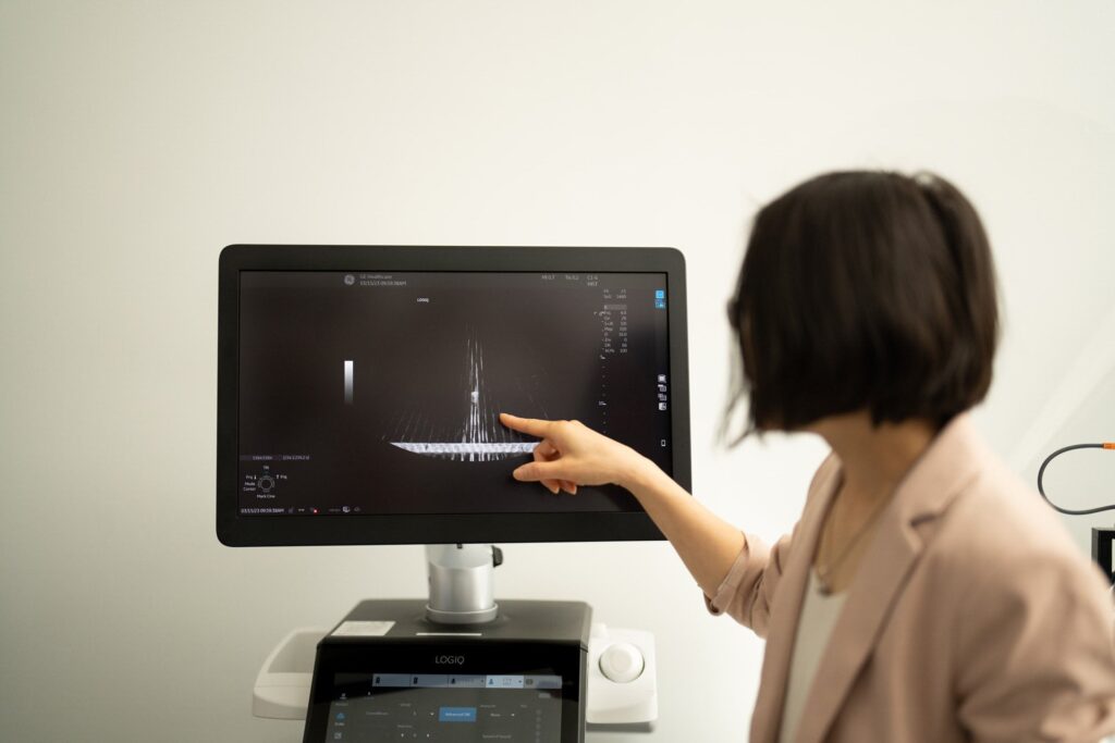 Zhen Xu stands and points at a monitor